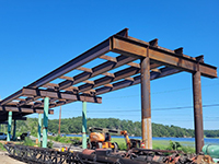 Metal bridge fram from ground view at work site.